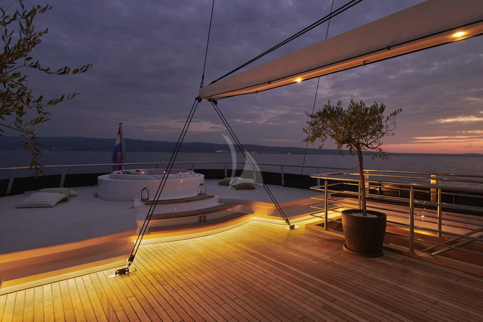 a deck with a boat and a tree on it aboard ANIMA MARIS Yacht for Sale