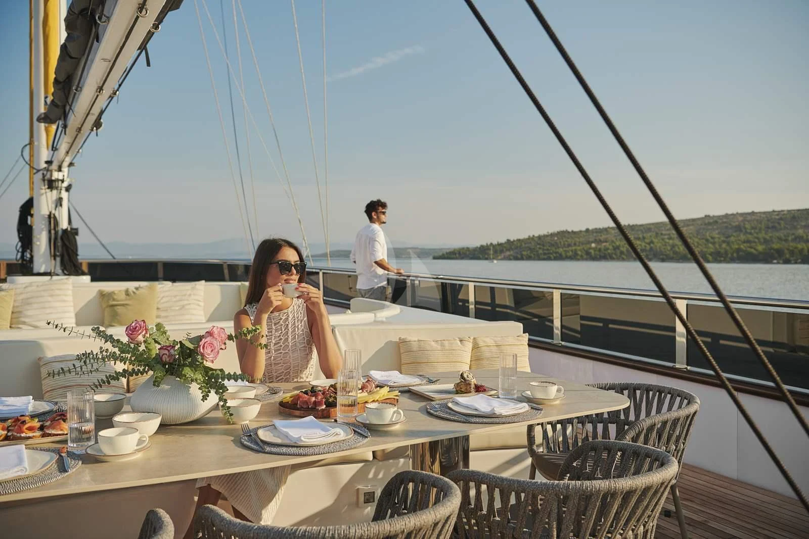 a person sitting at a table with food on it aboard ANIMA MARIS Yacht for Sale