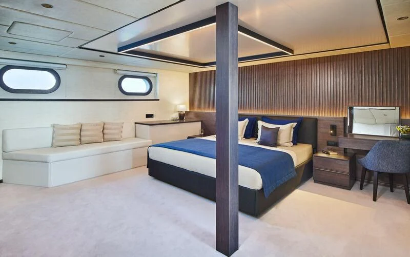 a room with a bed and a desk aboard ANIMA MARIS Yacht for Sale
