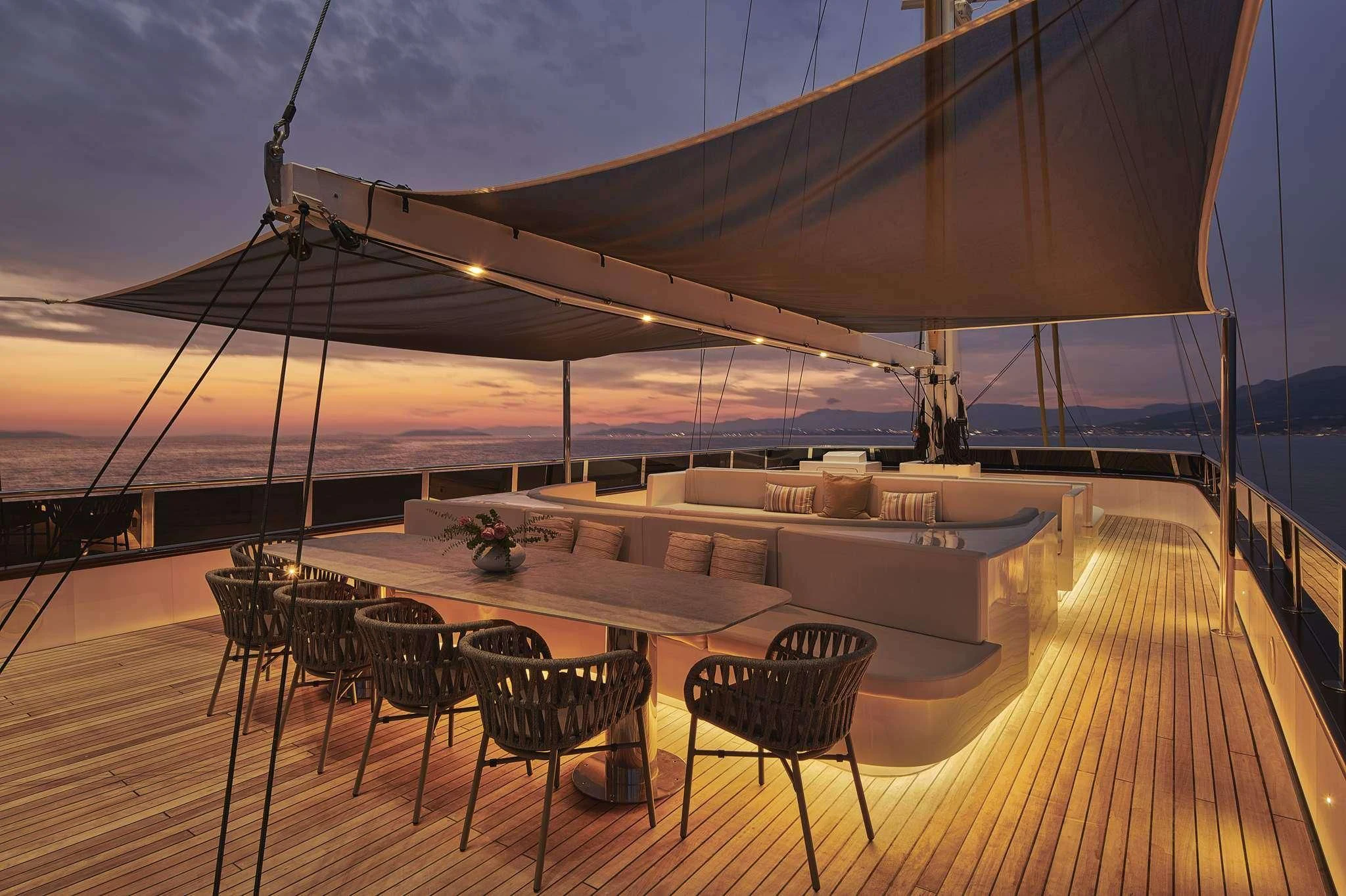 a deck with tables and chairs aboard ANIMA MARIS Yacht for Sale