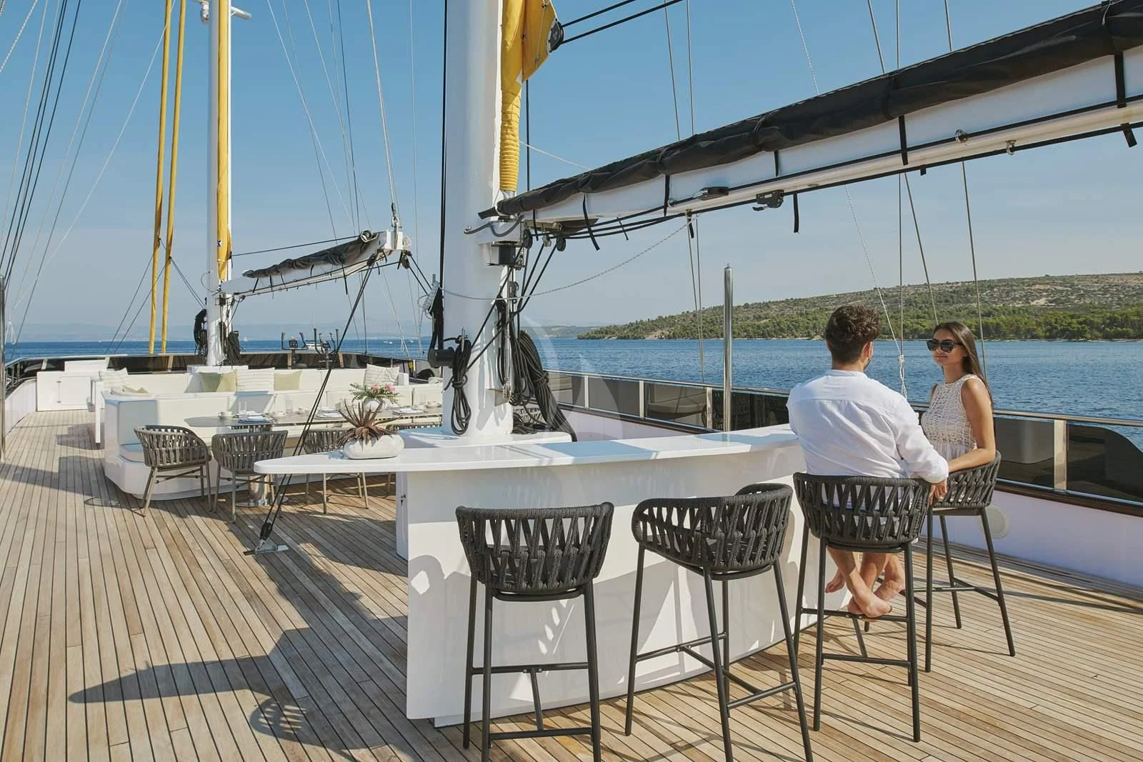 a couple sitting on a deck aboard ANIMA MARIS Yacht for Sale