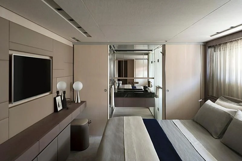 a room with a bed and a tv aboard NADHIRA Yacht for Sale