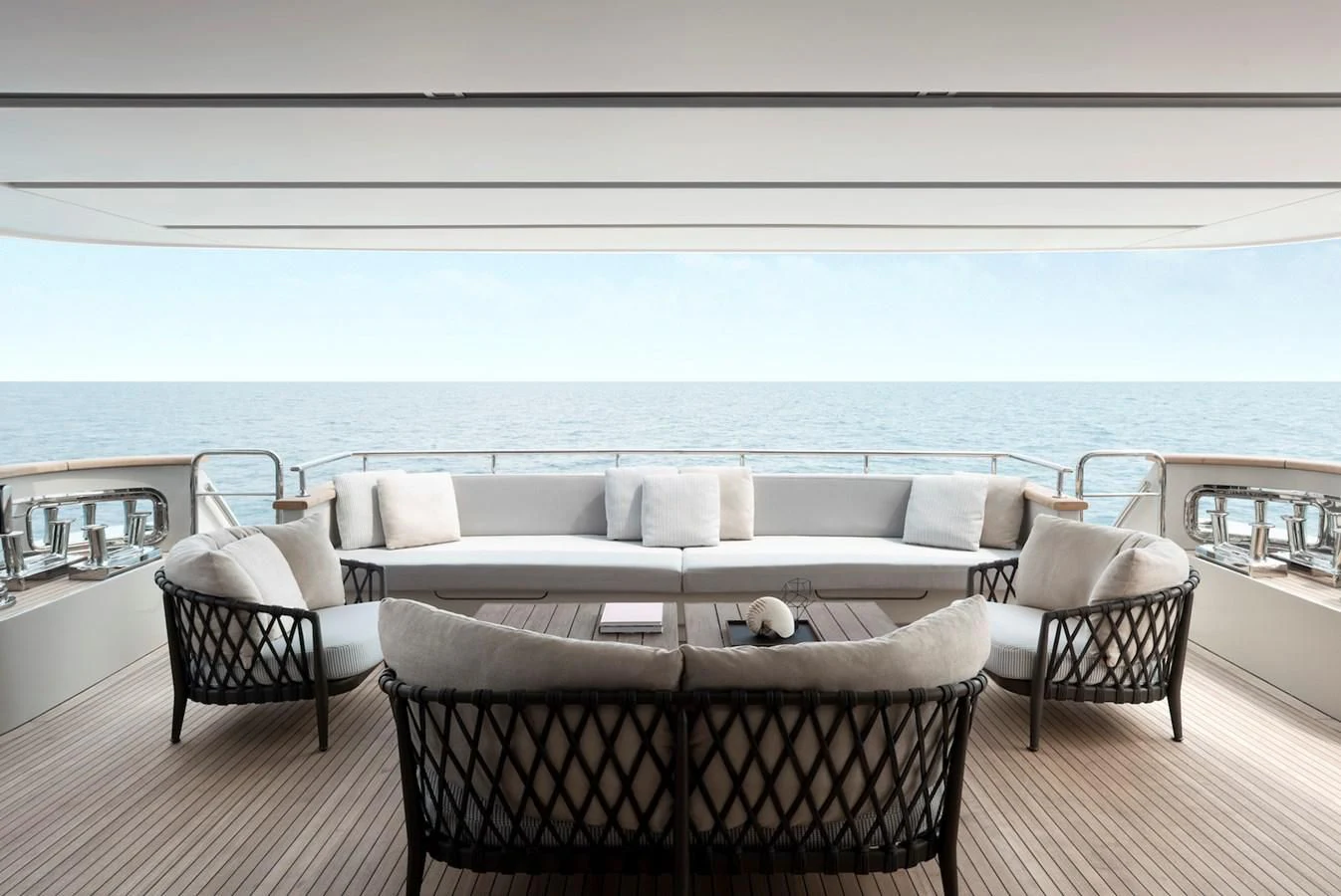 a large white couch and chairs on a deck overlooking the ocean aboard NADHIRA Yacht for Sale