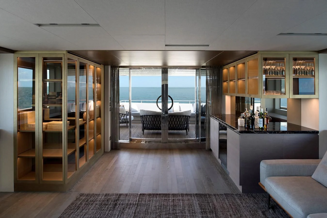 a room with a glass door and a wood cabinet aboard NADHIRA Yacht for Sale