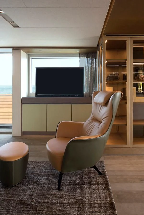 a room with a tv and a chair aboard NADHIRA Yacht for Sale