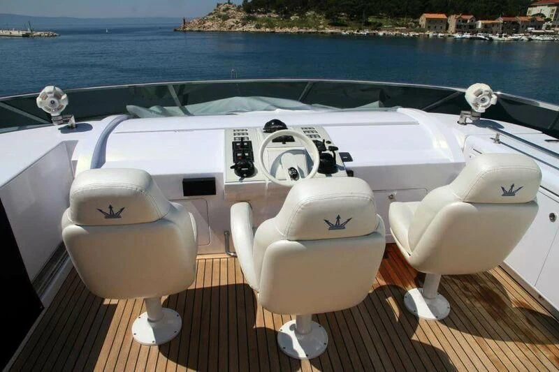 a couple of white boats on a deck by a body of water aboard HITECH RACING Yacht for Sale