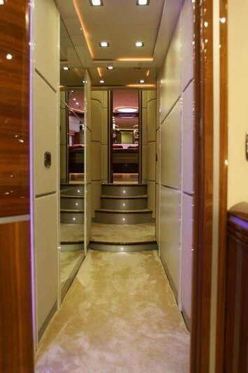 a hallway with a door and a staircase aboard HITECH RACING Yacht for Sale