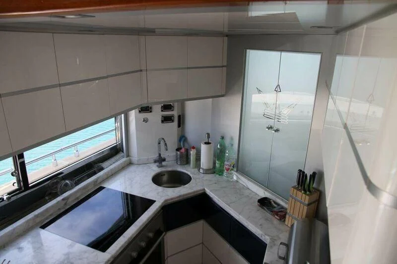 a kitchen with a sink and cabinets aboard HITECH RACING Yacht for Sale