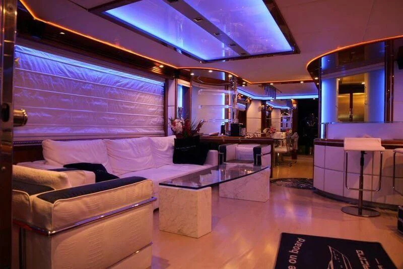 a room with a bed and a table aboard HITECH RACING Yacht for Sale