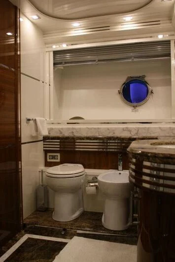 a bathroom with a toilet and a sink aboard HITECH RACING Yacht for Sale