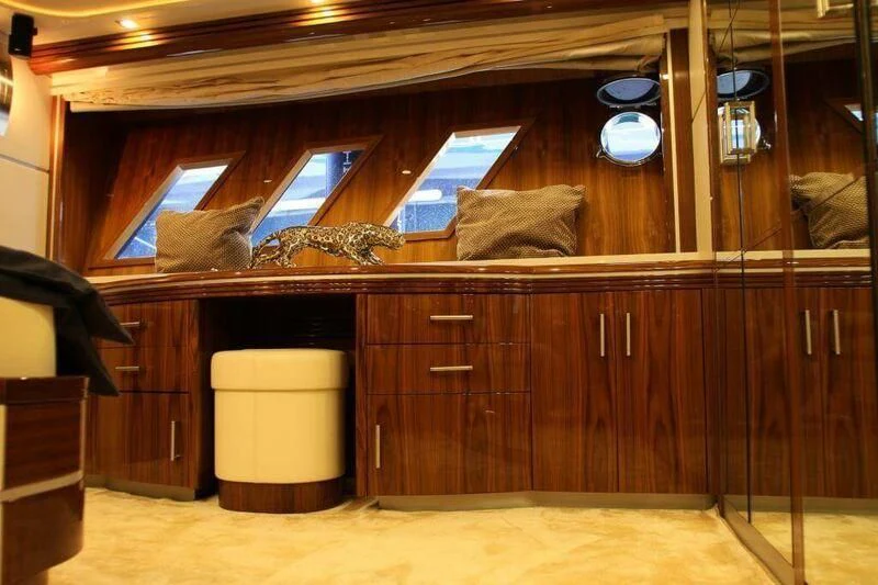 a room with a wood cabinet and a lamp aboard HITECH RACING Yacht for Sale