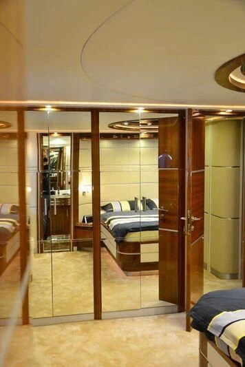 a room with a bed and a mirror aboard HITECH RACING Yacht for Sale