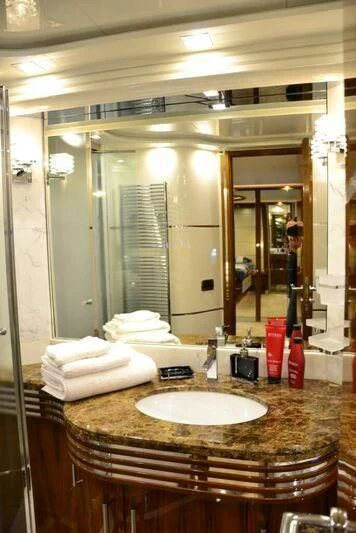 a bathroom with a large mirror aboard HITECH RACING Yacht for Sale