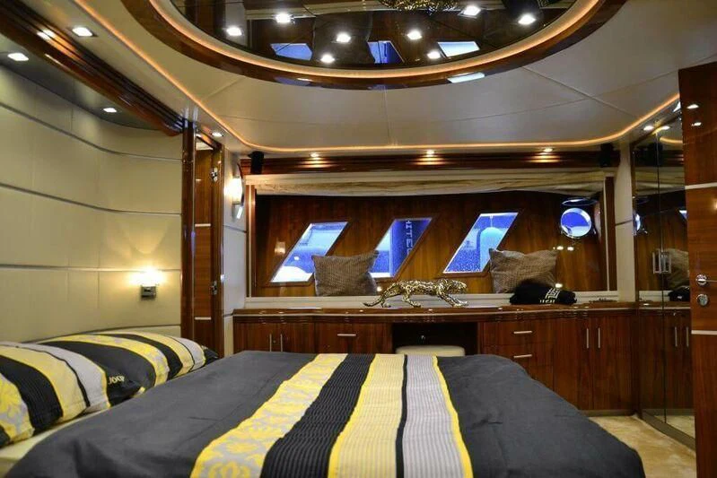 a room with a bed and a desk aboard HITECH RACING Yacht for Sale