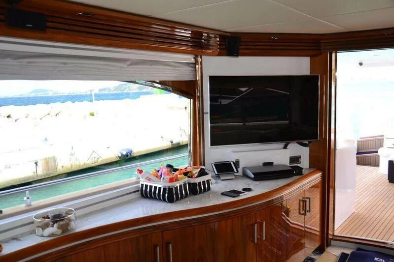 a kitchen with a television and a window aboard HITECH RACING Yacht for Sale