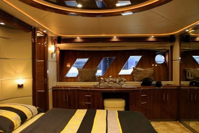 a room with a bed and a desk aboard HITECH RACING Yacht for Sale