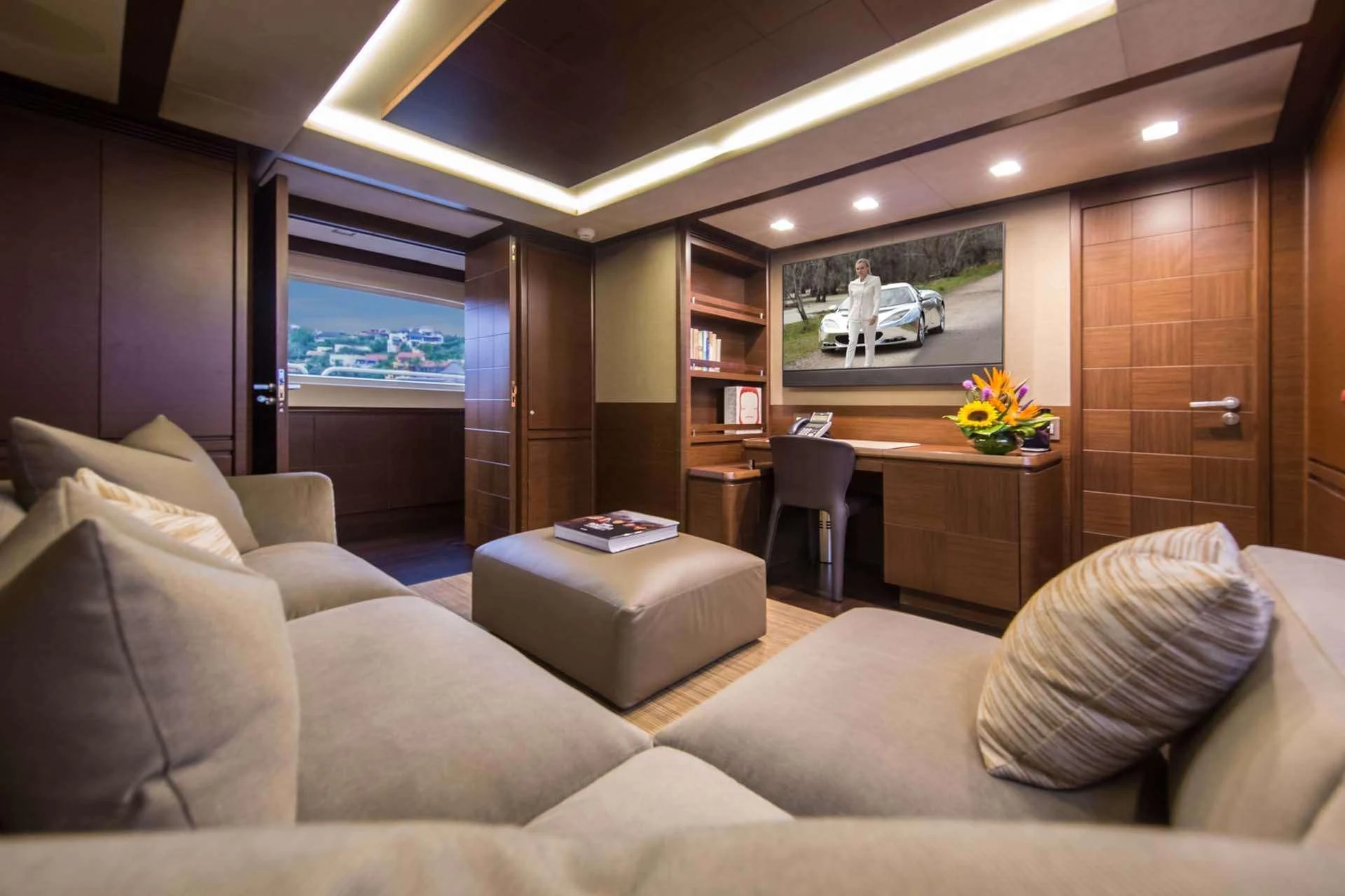 a living room with a large screen aboard AMANECER Yacht for Sale