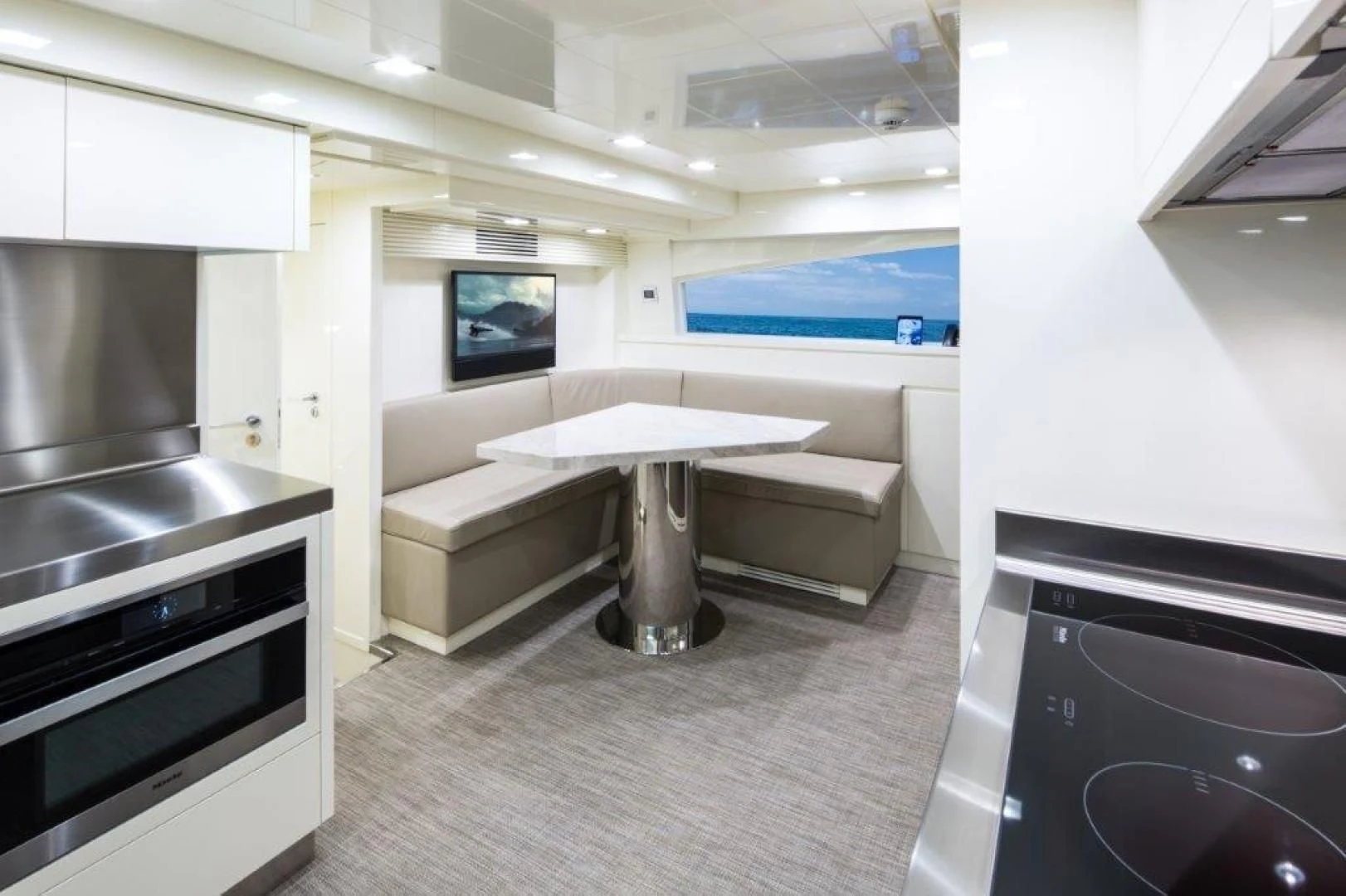 a room with a table and a couch aboard AMANECER Yacht for Sale