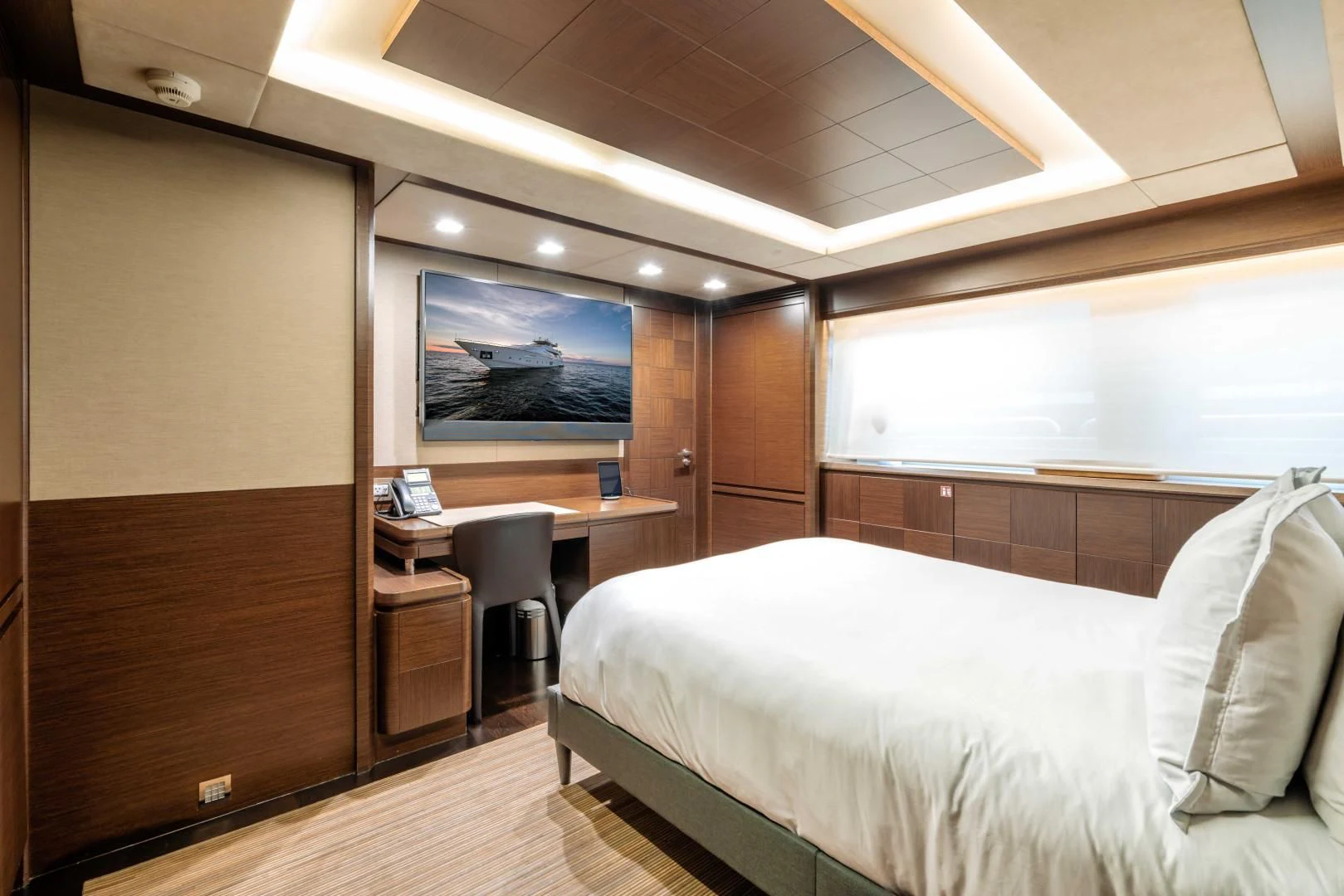 a room with a bed and a desk aboard AMANECER Yacht for Sale