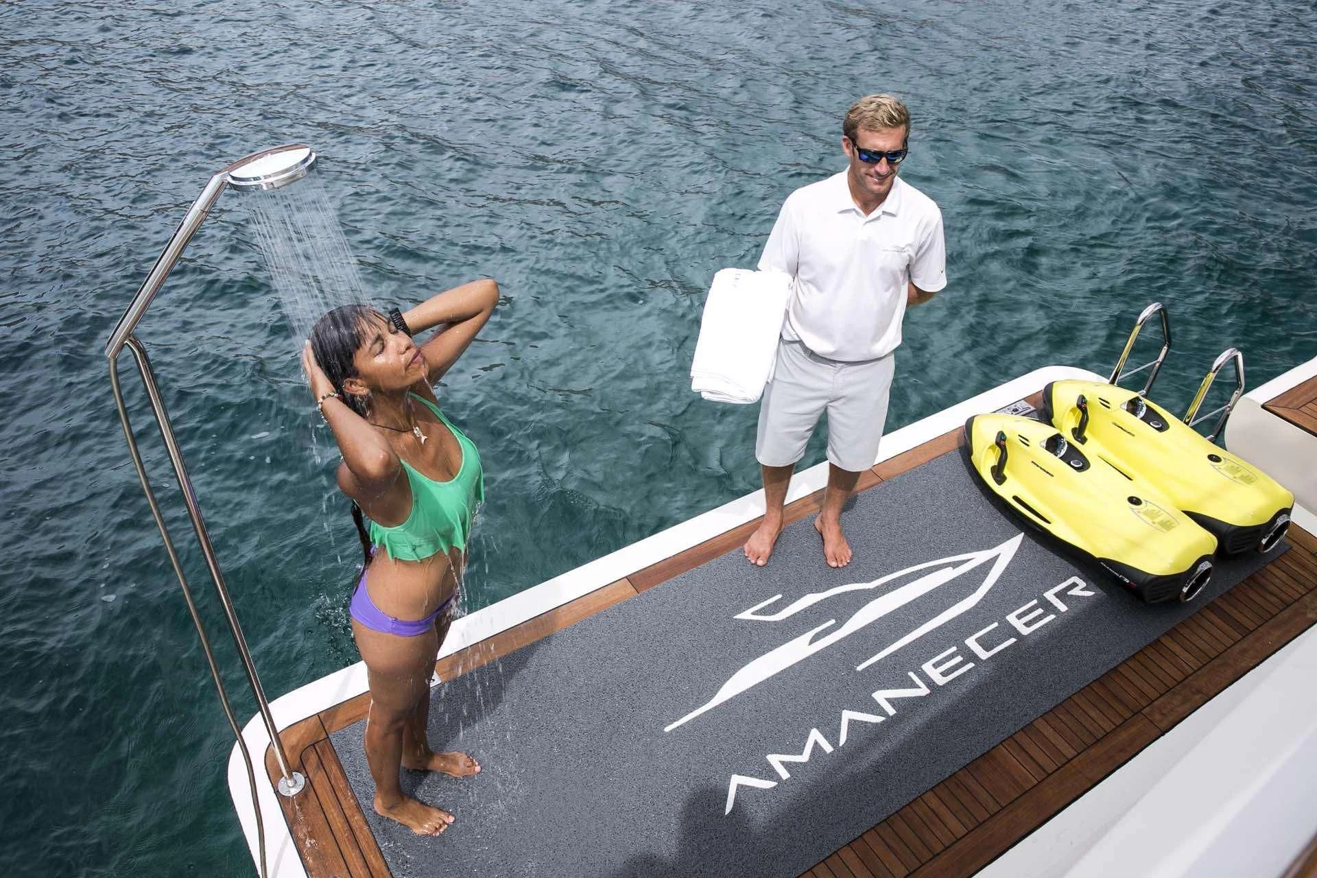 a woman and a man on a boat aboard AMANECER Yacht for Sale