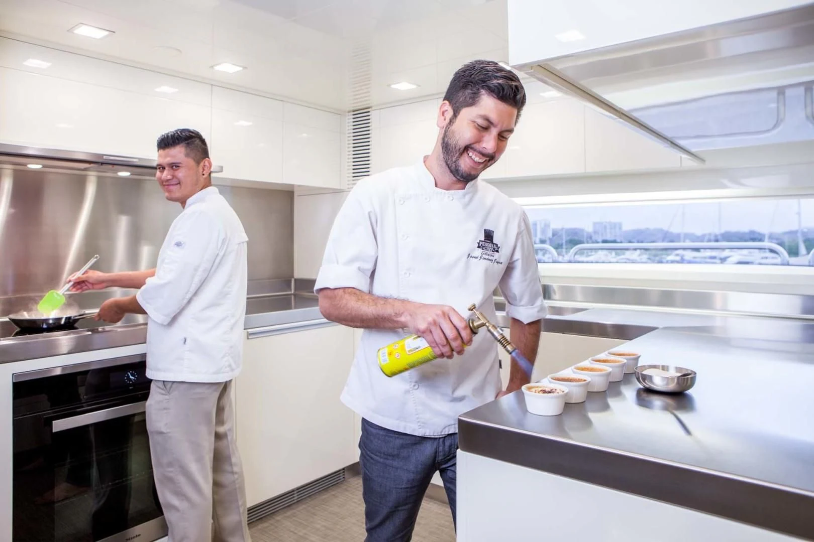 a couple of men in a kitchen aboard AMANECER Yacht for Sale