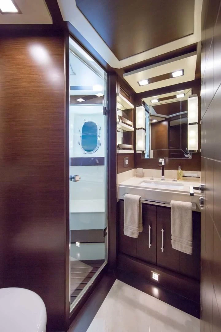 a bathroom with a glass shower aboard AMANECER Yacht for Sale