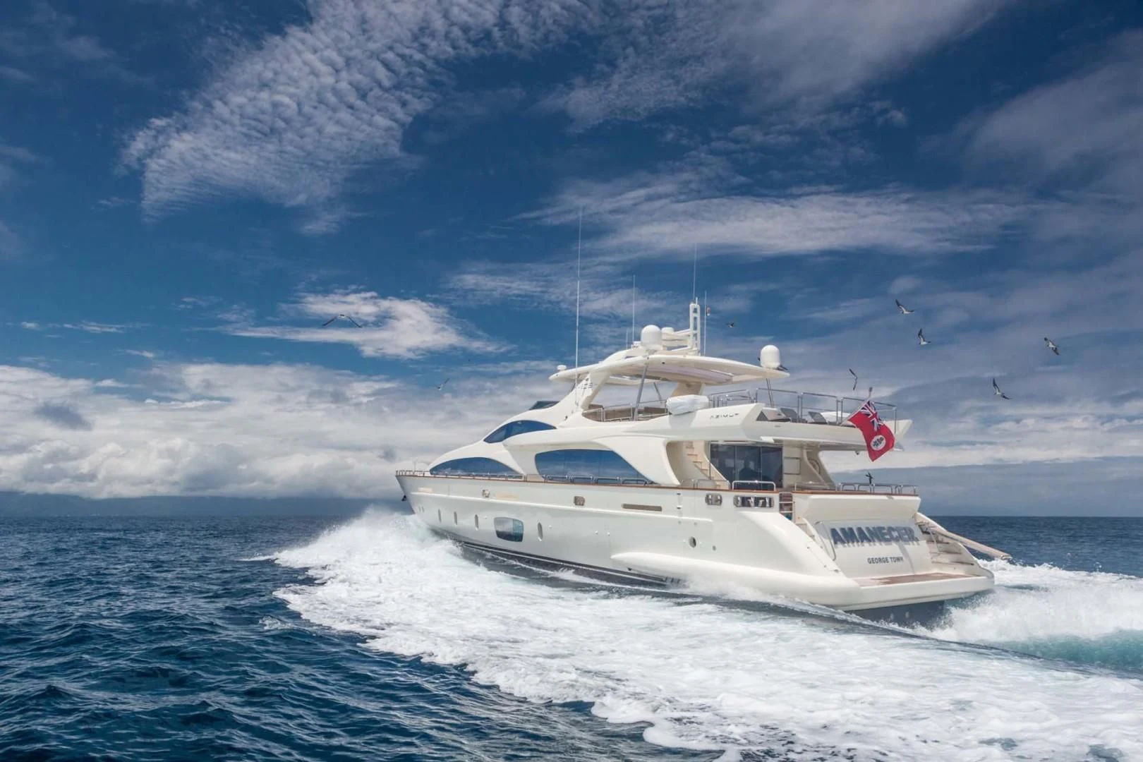 a white yacht in the ocean aboard AMANECER Yacht for Sale