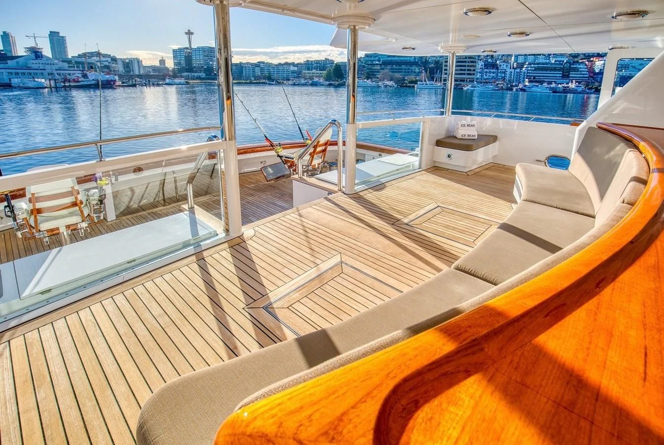 a deck with a large body of water and a city in the background aboard ICE BEAR Yacht for Sale