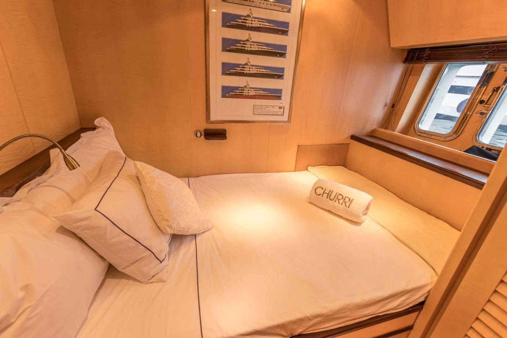 a bed with a phone on it aboard CHURRI Yacht for Sale