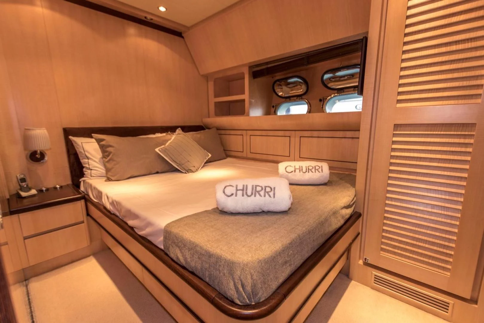 a bed with a white pillow aboard CHURRI Yacht for Sale