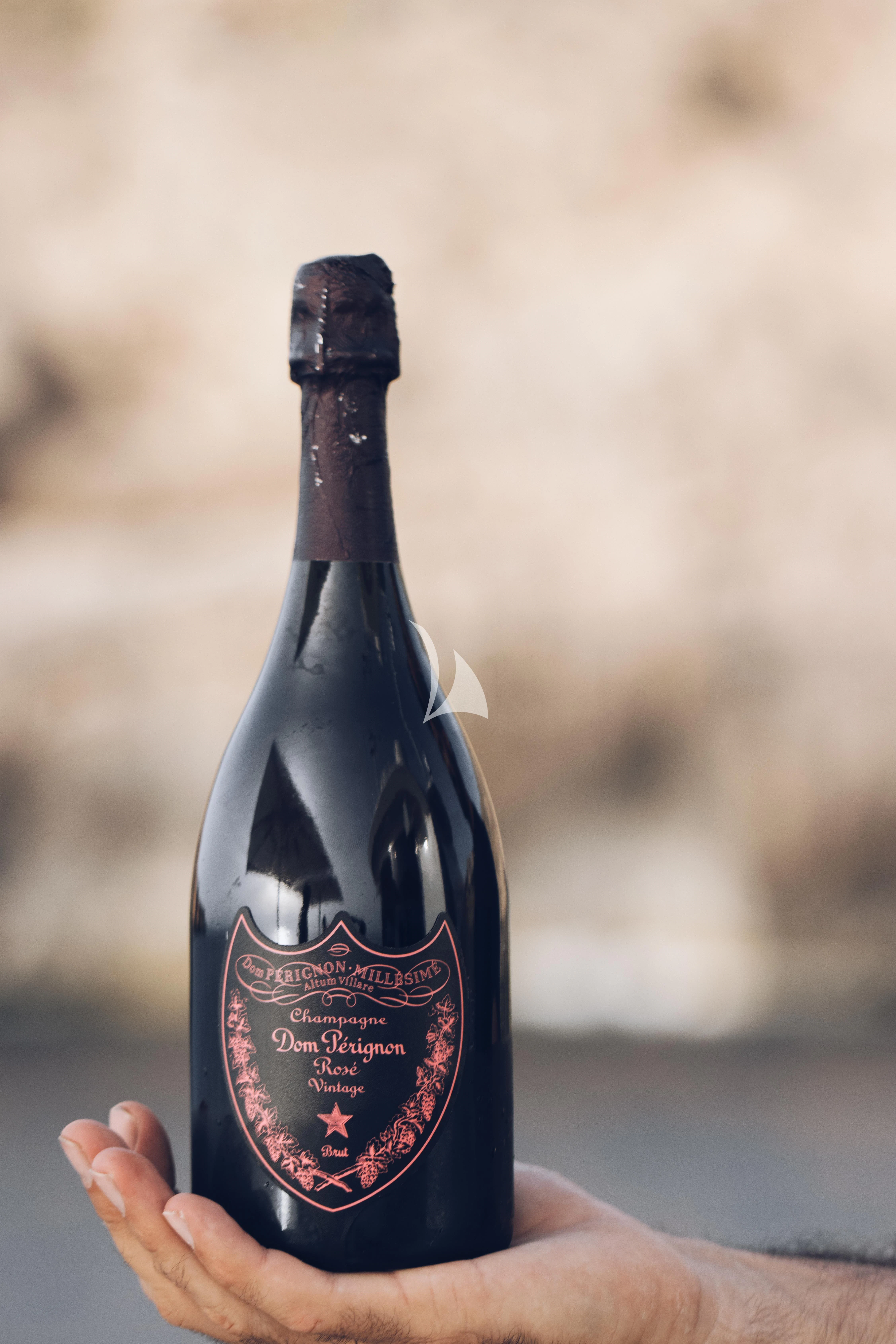 a hand holding a bottle aboard CHURRI Yacht for Sale