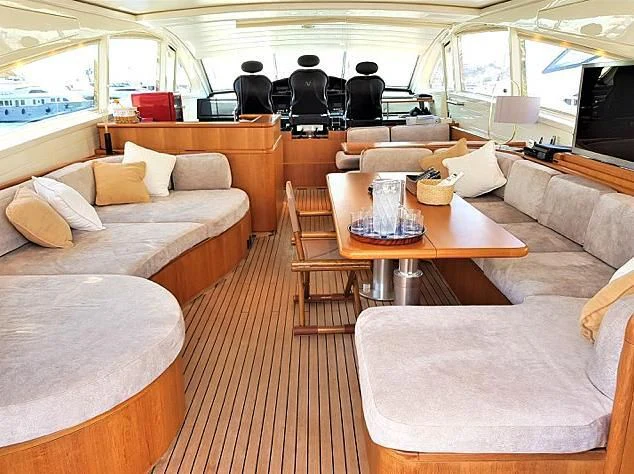 a living room with a table and couches aboard CHURRI Yacht for Sale