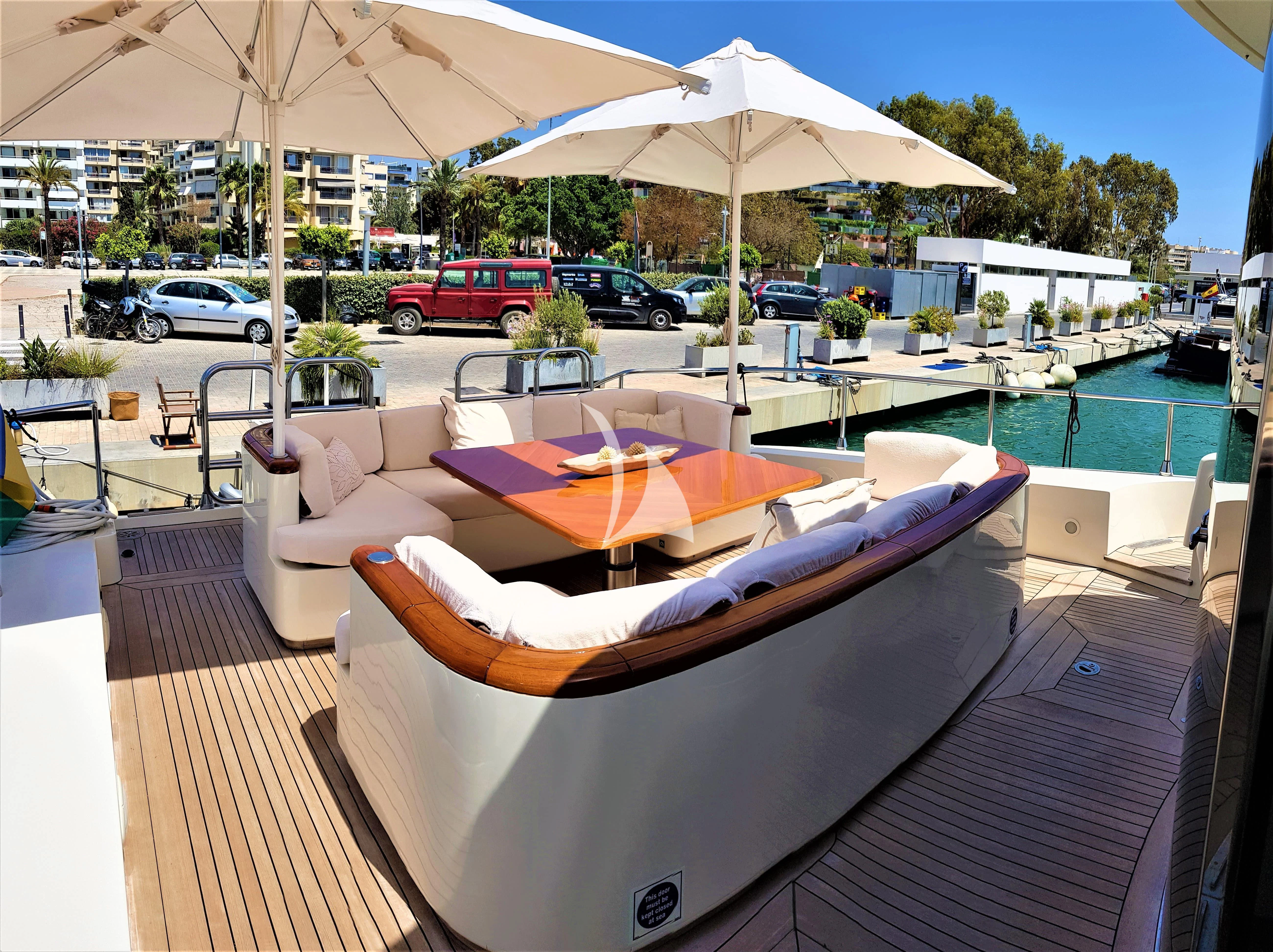 a pool with a table and umbrella aboard CHURRI Yacht for Sale