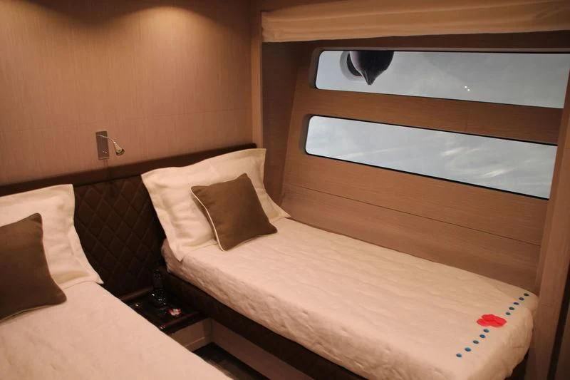 a bed with a white pillow and a wooden headboard aboard TSA TSA Yacht for Sale