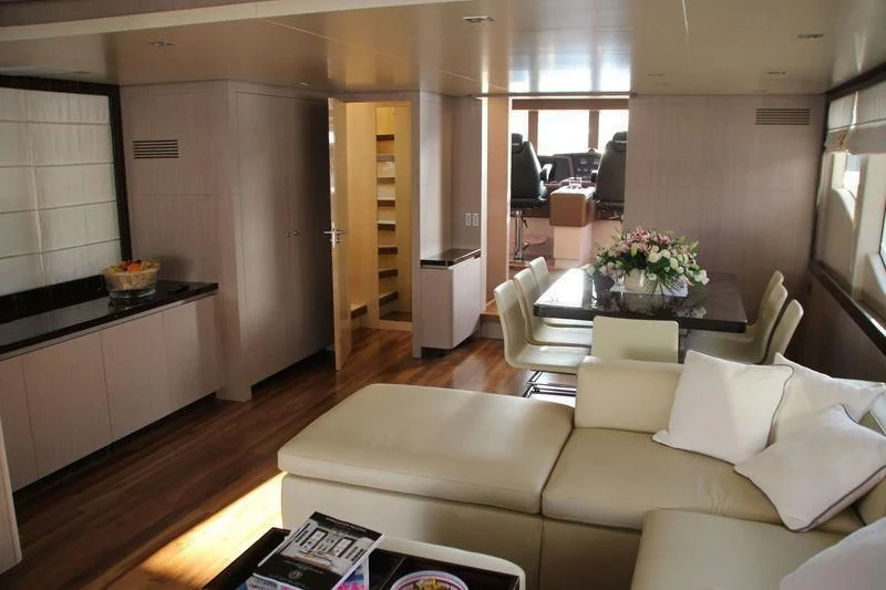 a living room with a couch and a table aboard TSA TSA Yacht for Sale
