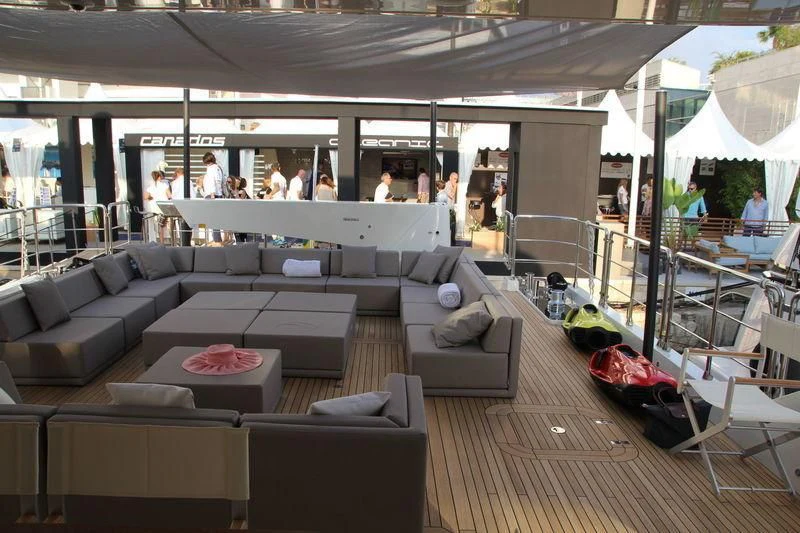 a large lounge area with a large window and a group of people aboard TSA TSA Yacht for Sale