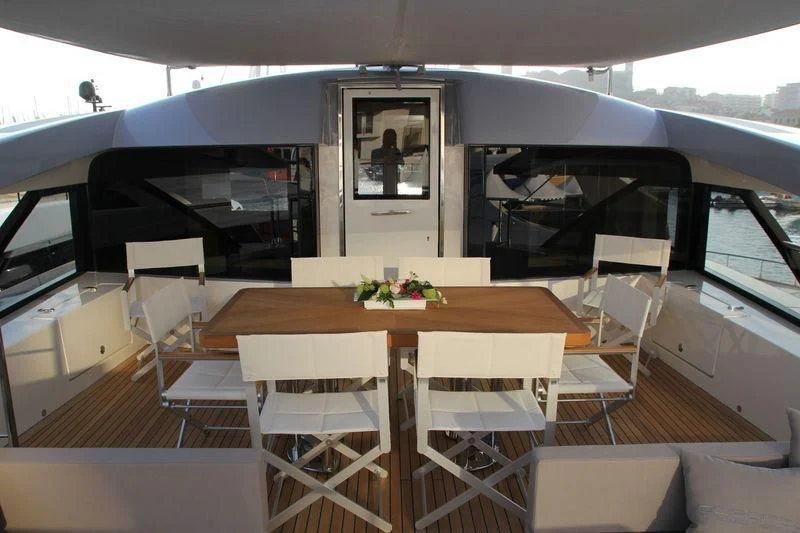 a room with a table and chairs aboard TSA TSA Yacht for Sale