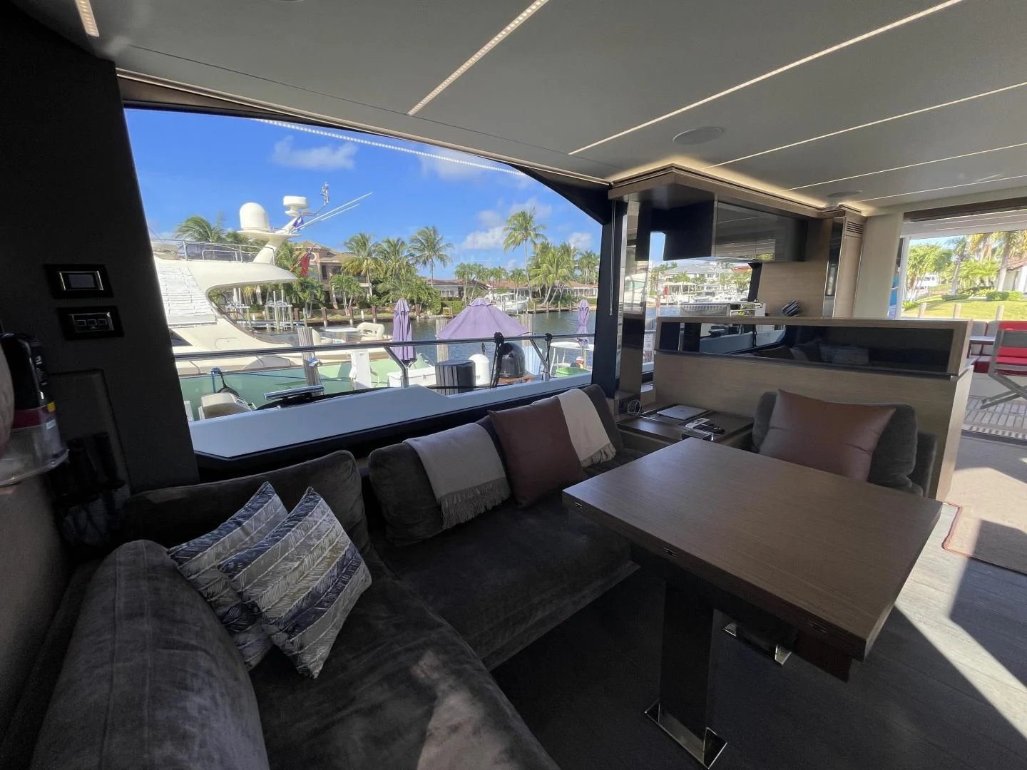 a living room with a large window aboard LEBRADA Yacht for Sale