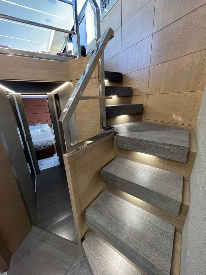 a wooden staircase in a building aboard LEBRADA Yacht for Sale
