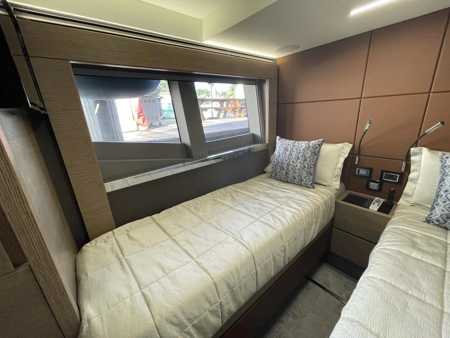 a room with a bed and a window aboard LEBRADA Yacht for Sale
