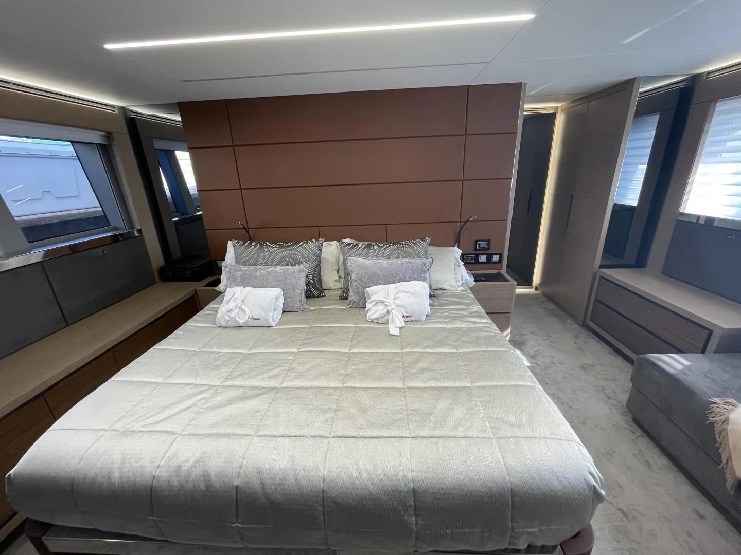 a bed with pillows on it aboard LEBRADA Yacht for Sale