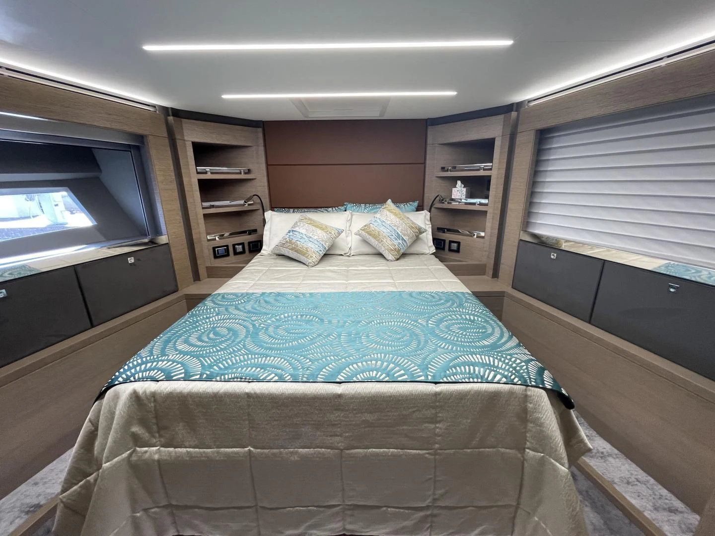 a bedroom with a bed and a bookcase aboard LEBRADA Yacht for Sale