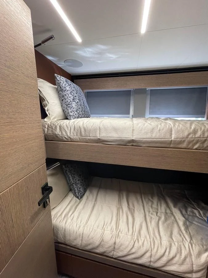 a bed with a wooden frame aboard LEBRADA Yacht for Sale