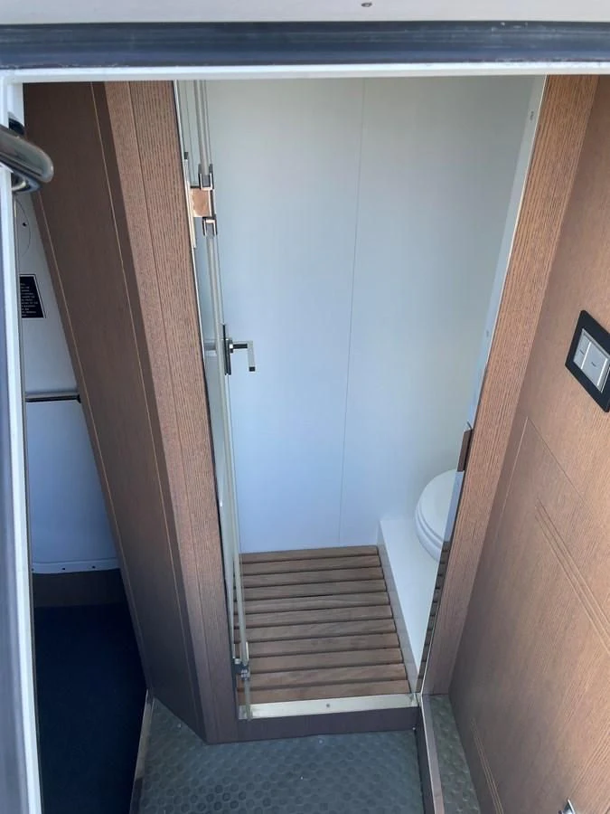 a bathroom with a door aboard LEBRADA Yacht for Sale