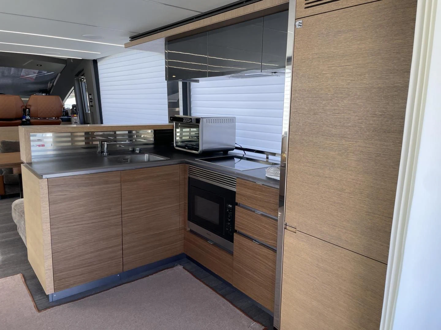 a kitchen with wooden cabinets aboard LEBRADA Yacht for Sale