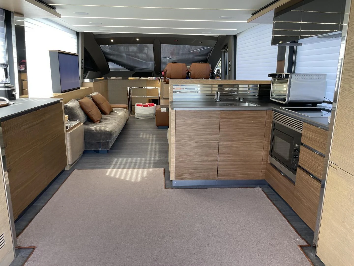 a kitchen with a microwave oven and a couch aboard LEBRADA Yacht for Sale