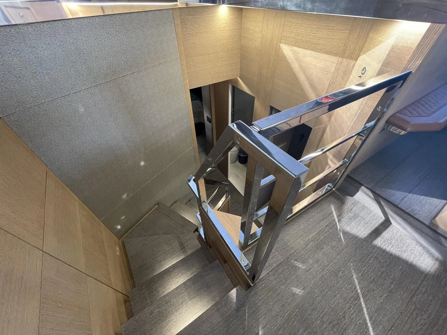a wooden staircase with a railing aboard LEBRADA Yacht for Sale
