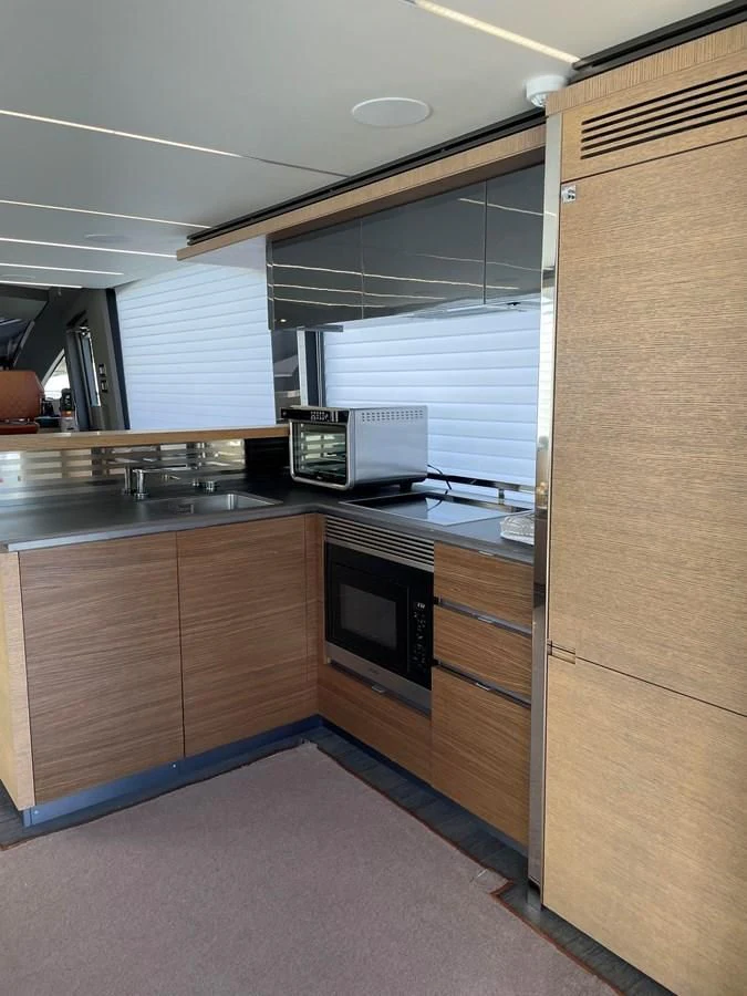 a kitchen with wooden cabinets aboard LEBRADA Yacht for Sale