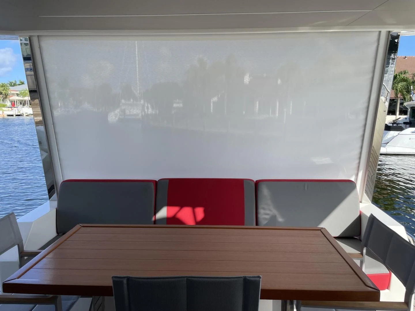 a large screen with a table and chairs on it aboard LEBRADA Yacht for Sale