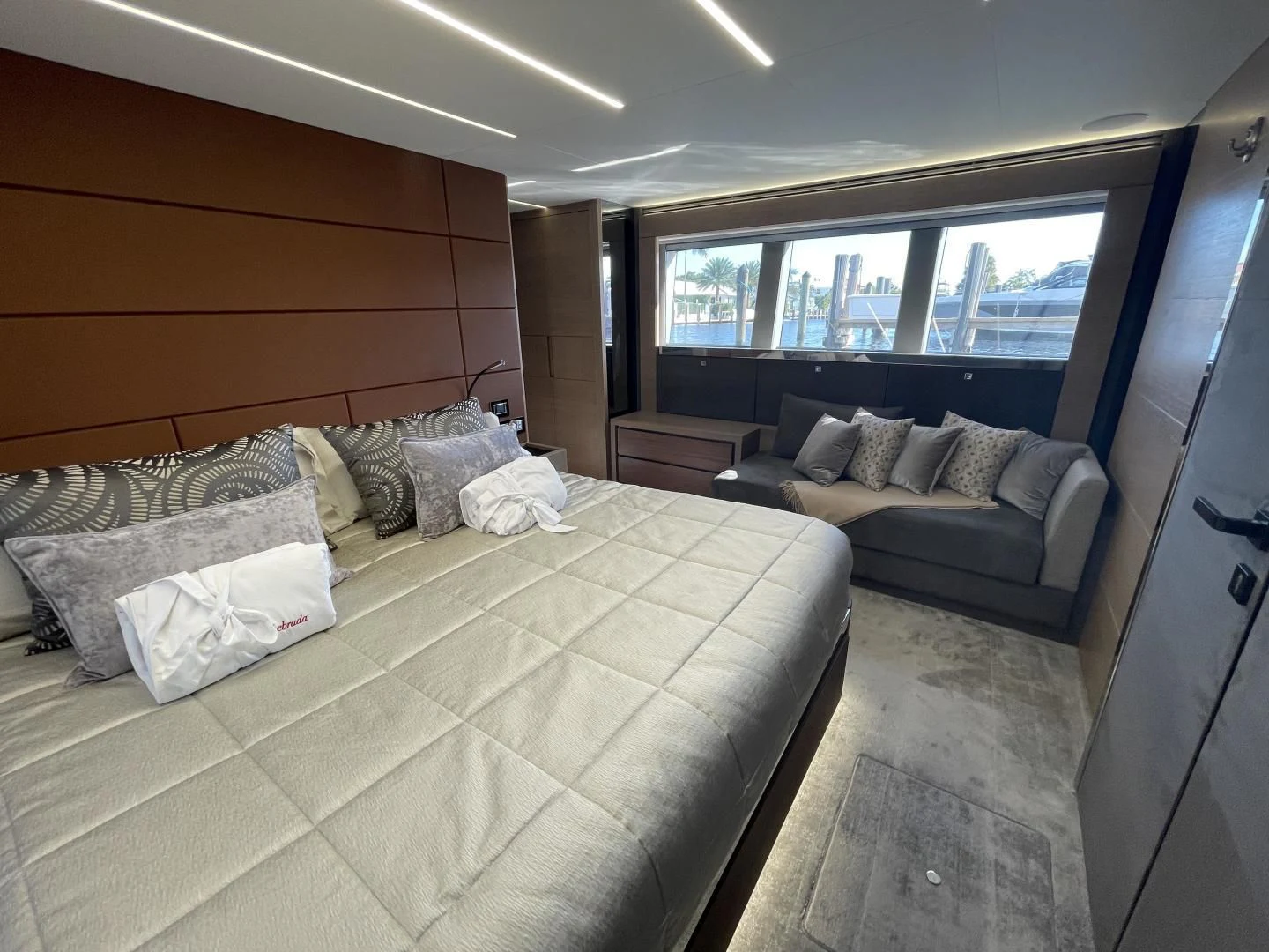 a bedroom with a bed and a couch aboard LEBRADA Yacht for Sale